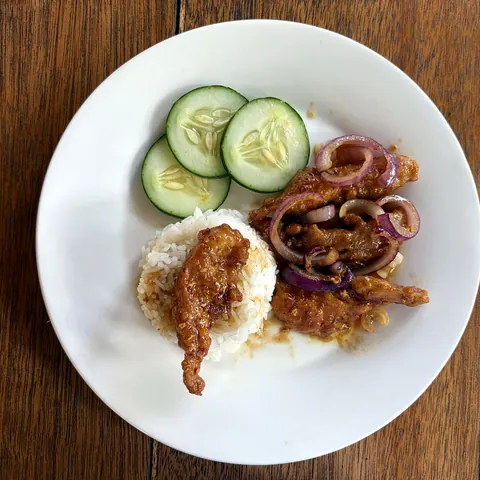 Filipino breakfast with rice, cucumber and chicken